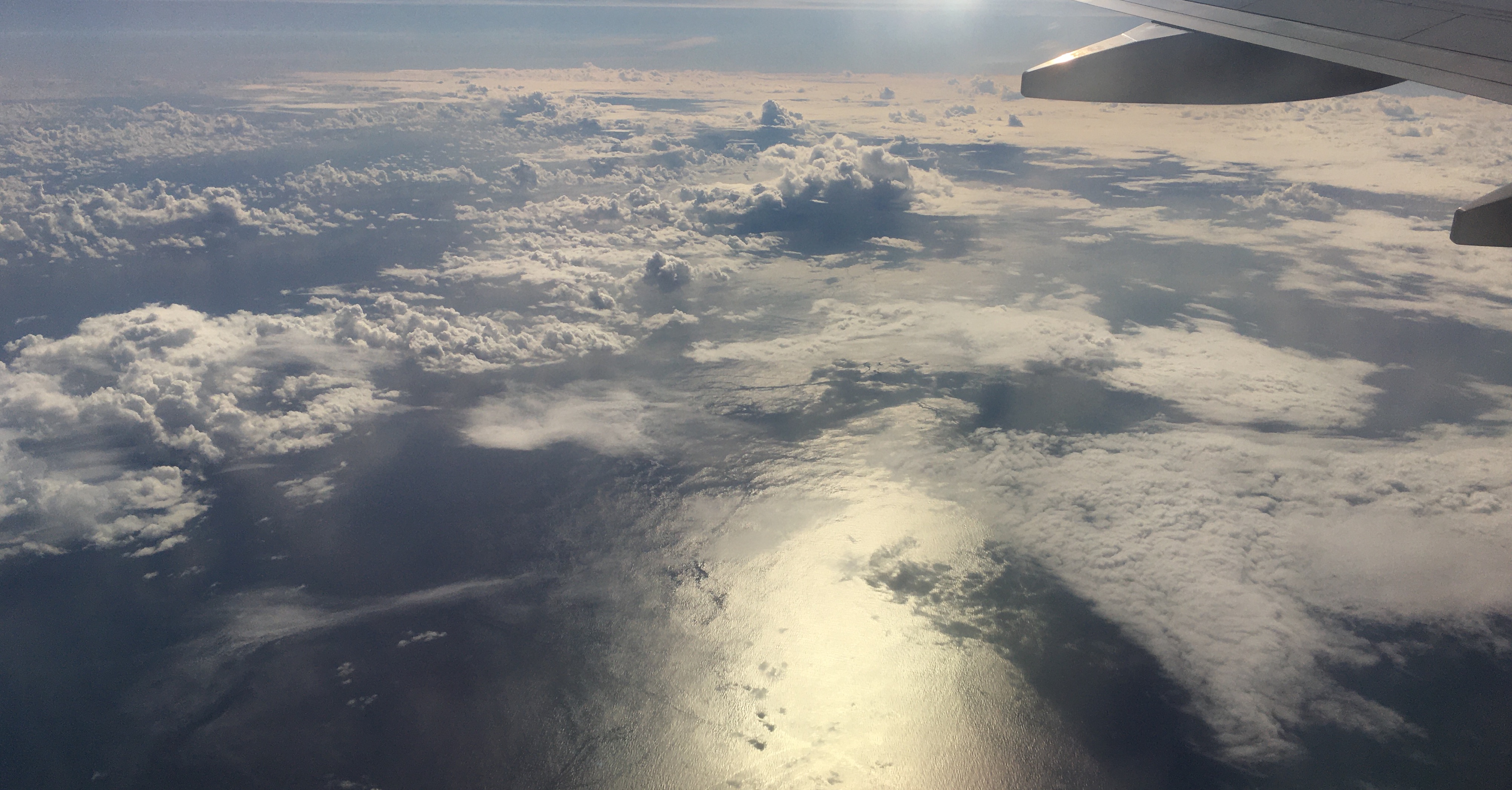 Photograph of shallow cumulus clouds with a variety of
	 cloud top heights and a mix of stratiform and convective
	 cloud cover as well as clear sky